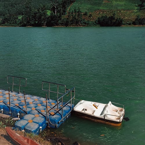 Mattupetty Lake and pedal boat tied to a dock in Munnar