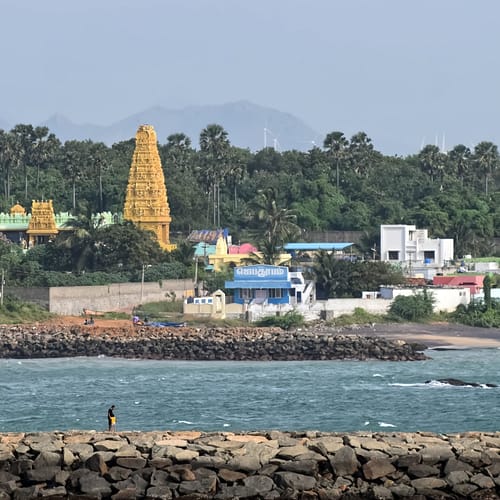 Ocean view from breakwater with village in background located in Kanyakumari.