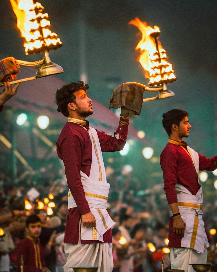men holding lamp at hindu ceremony