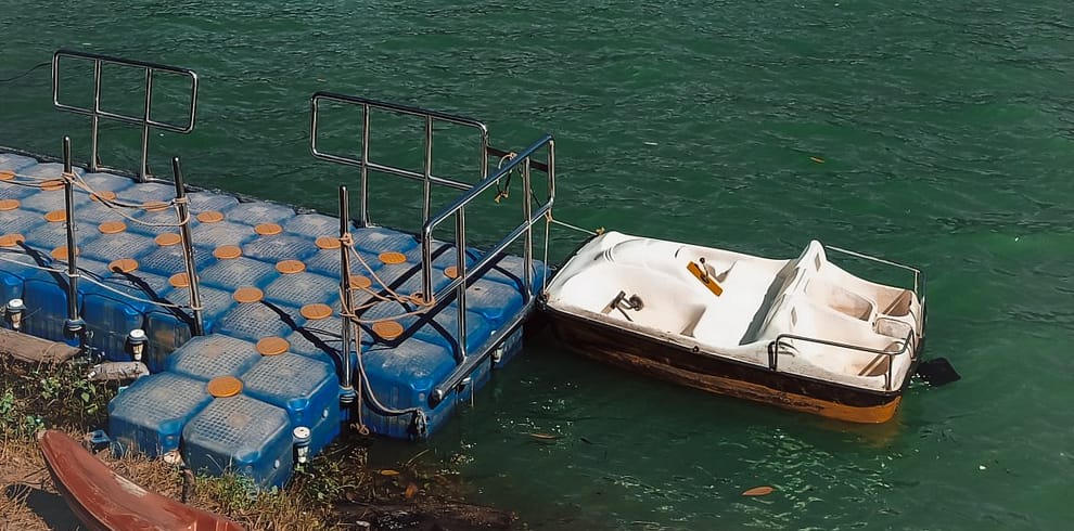 Mattupetty Lake and pedal boat tied to a dock in Munnar