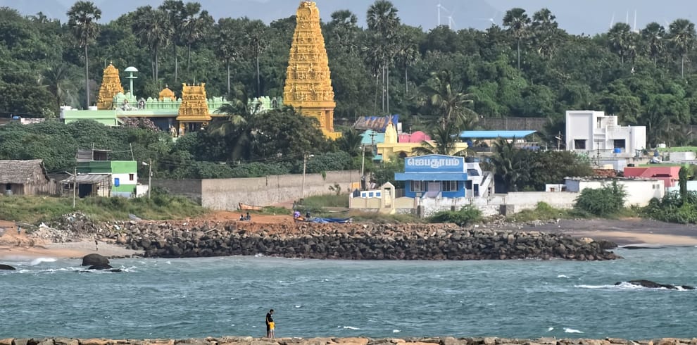 Ocean view from breakwater with village in background located in Kanyakumari.