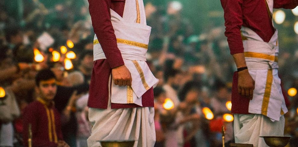 men holding lamp at hindu ceremony