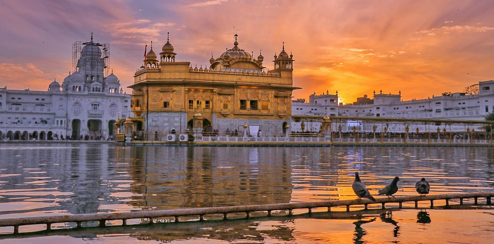 golden temple near water in evening